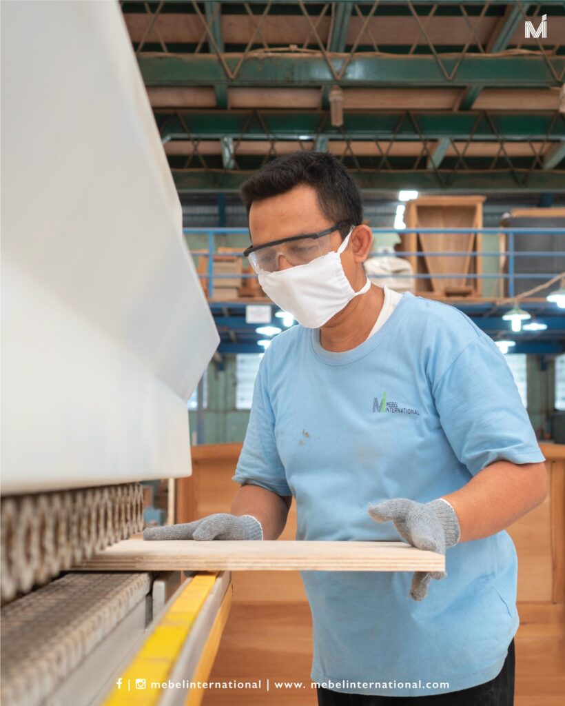 Mebel International furniture manufacturer worker operating woodworking sanding machine