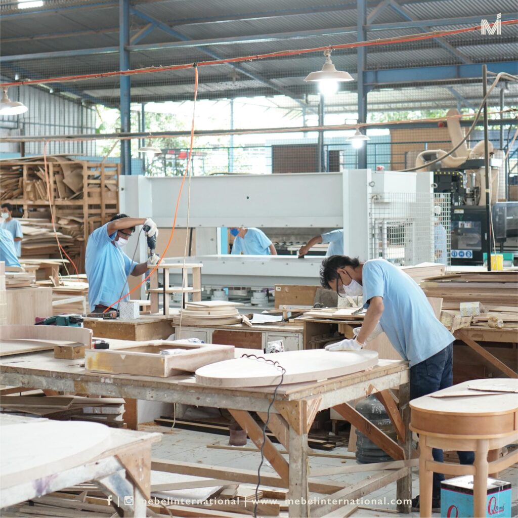 Craftsmen at Mebel International furniture manufacturer assembling wooden furniture components