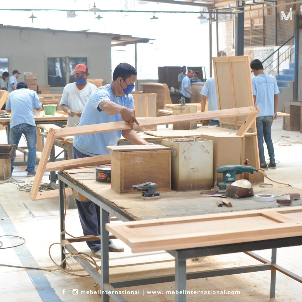 Mebel International furniture manufacturer team assembling wooden furniture frames in workshop