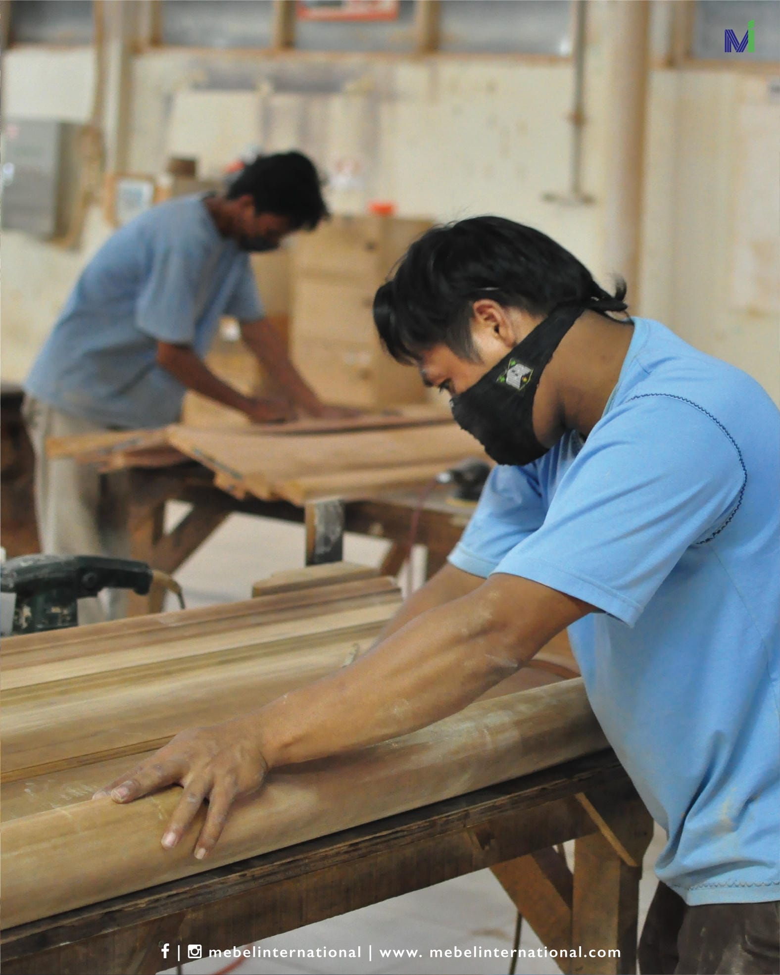 Craftsman sanding wood panel at Mebel International furniture manufacturer workshop