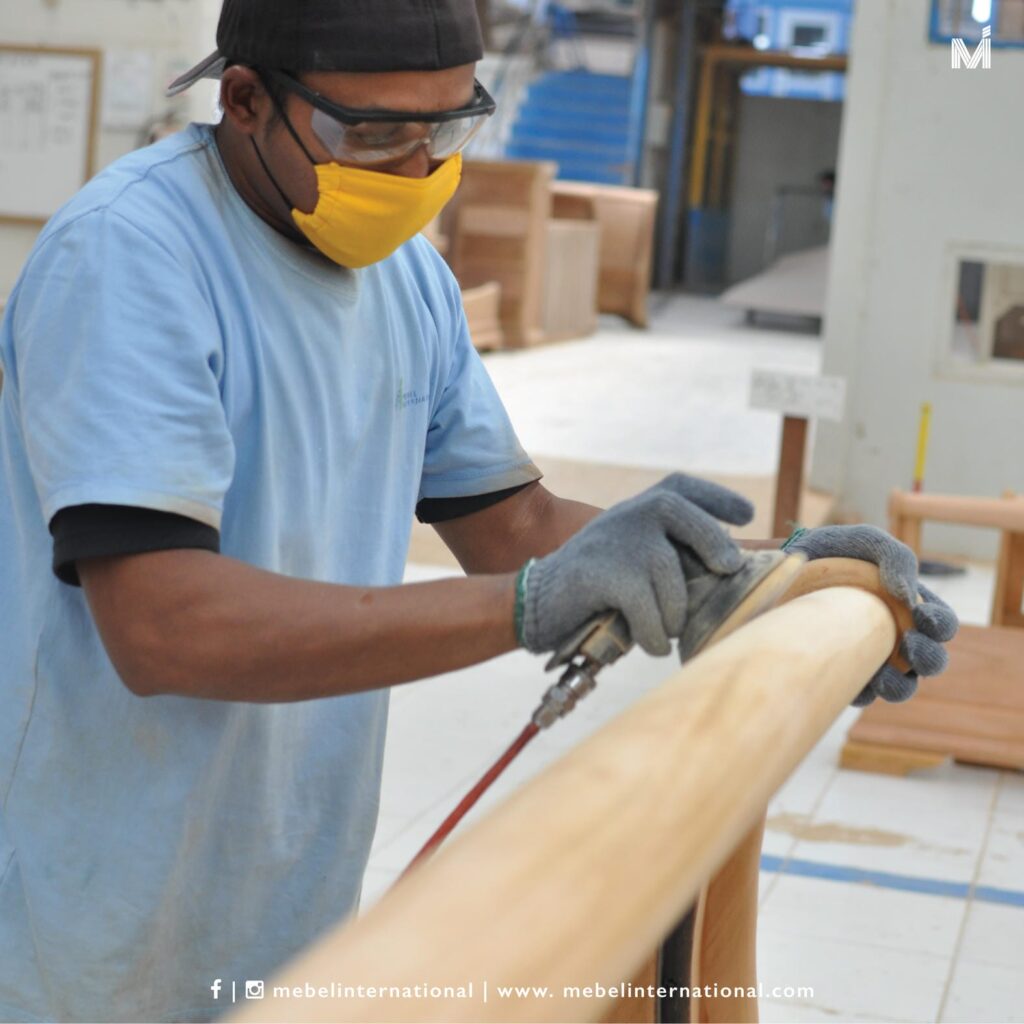 Mebel International furniture manufacturer craftsman sanding curved wooden furniture component
