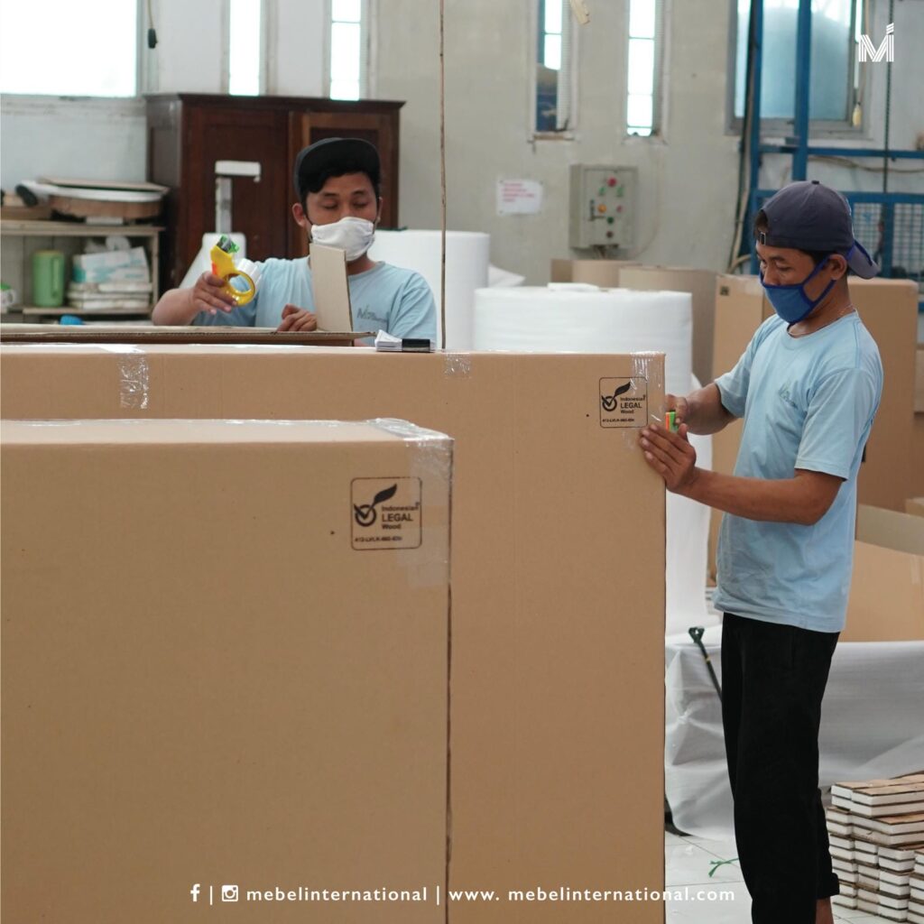 Mebel International furniture manufacturer team sealing export furniture packaging boxes