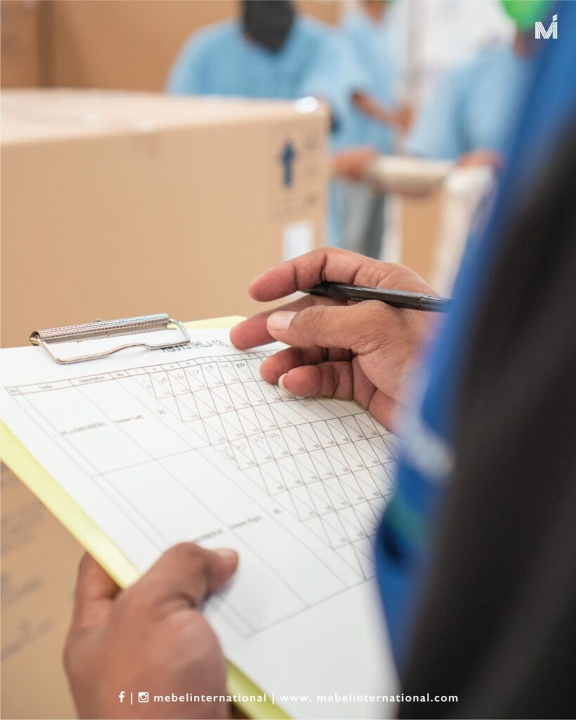 Mebel International furniture manufacturer staff checking production checklist during packaging