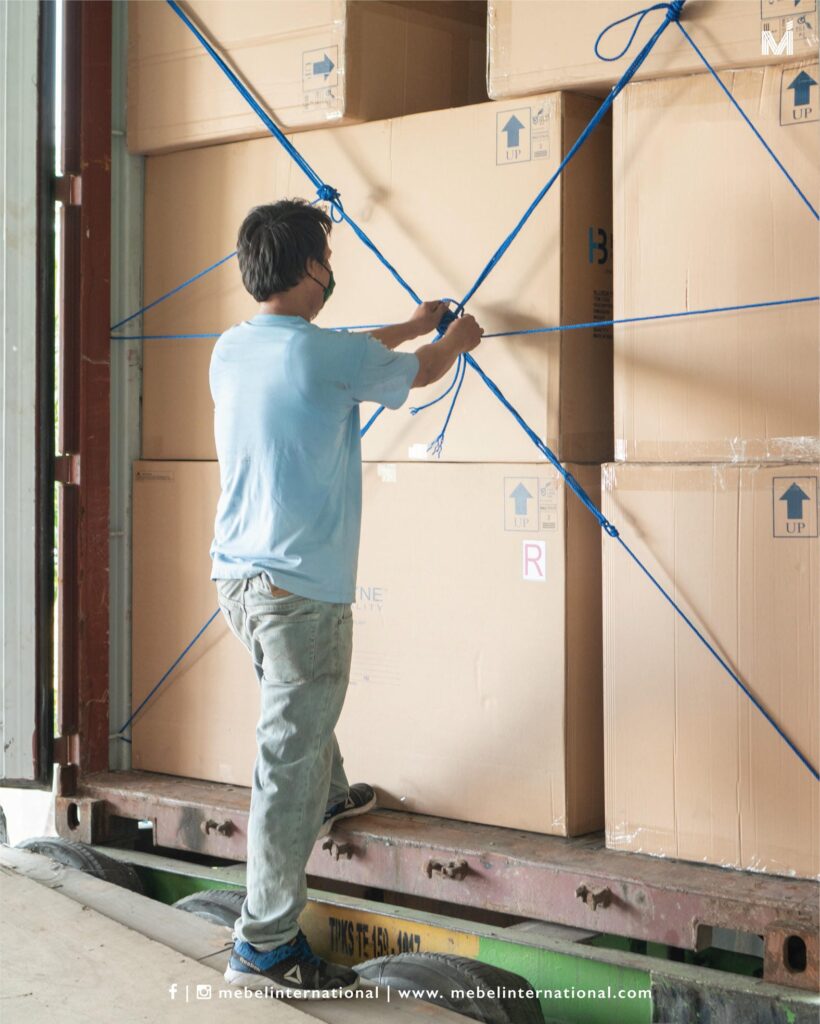 Worker securing export cartons with ropes, furniture manufacturer Mebel International