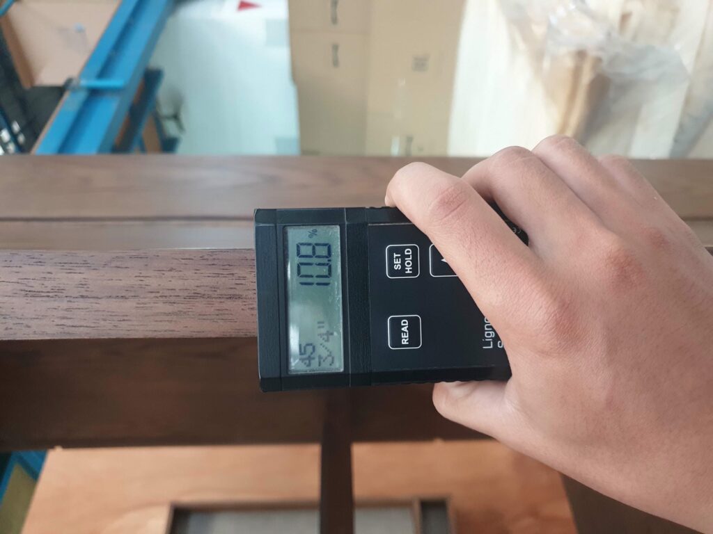 Mebel International furniture manufacturer measuring wood moisture with digital meter