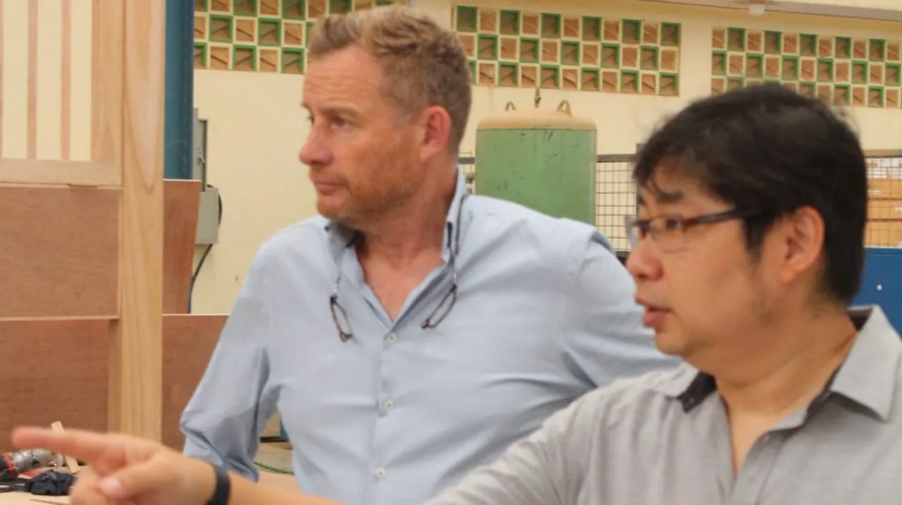 Mebel International furniture manufacturer team discussing production inside factory